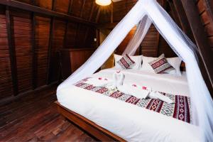 a bedroom with a bed with a mosquito net at Viyana Ubud Villas in Ubud +43 photos