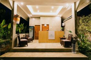 a lobby with chairs and a reception desk at Viyana Ubud Villas in Ubud