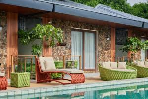a patio with chairs and a swimming pool at Casa Mithi Private Villas Resort in Mexico