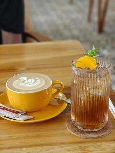 a cup of coffee sitting on a table with a drink at Viyana Ubud Villas in Ubud