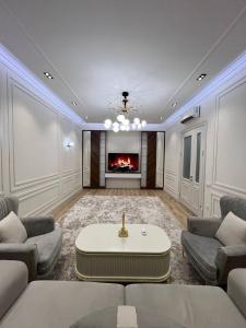 a living room with a couch and a fireplace at Toshkent city apartments in Tashkent