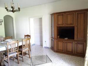 a dining room with a table and a television at Casa di Biagio e Maria in Trecchina