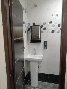 a bathroom with a sink and a tv on the wall at Diamond Ridge Living 1RK G-02 in Haidar Sāhibgūda +12 photos