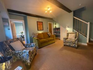 a living room with a couch and two chairs at Scale Hill Hotel in Loweswater +65 photos