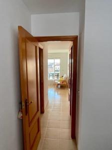 a hallway with an open door to a room at Apartamento en playa de Torrenostra in Torrenostra +1 photo