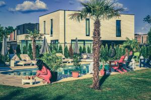 een vrouw op een bankje naast een zwembad bij B&B 1001 nacht in Zonhoven