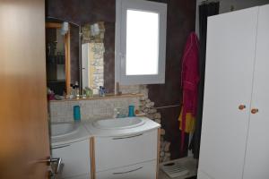 a bathroom with a sink and a mirror at Mafadel in Cluny +5 photos
