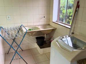 a bathroom with a sink and a toilet at Villa Ipe in Patos de Minas +10 photos