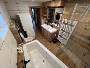 a bathroom with a tub and a sink and a shower at Apartmán Horal in Jilemnice