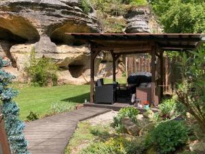 a wooden pergola with a table and chairs in a garden at Wellness Kokořín in Kokořín +9 photos