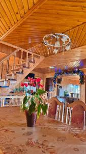 a dining room with a table and a potted plant at U Nazara in Slavske