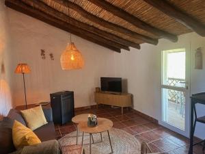 a living room with a couch and a tv at B&B Sol y Monte in Alora