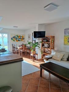 a living room with a couch and a table at Casa Hess in Velden am Wörthersee