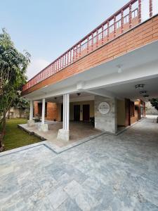 a large brick building with a large patio at Hotel living spot in Lahore
