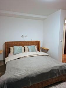 a bedroom with a large bed with blue pillows at Casa Hess in Velden am Wörthersee