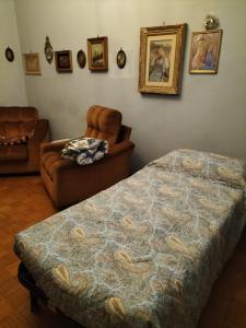 a bedroom with a bed and a chair at Lara home in Gaglianico