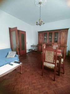 a living room with a blue couch and a table at Lara home in Gaglianico