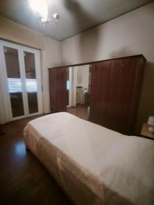 a bedroom with a large bed and a large mirror at Lara home in Gaglianico