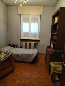 a bedroom with a bed and a window at Lara home in Gaglianico