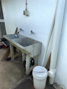 a concrete sink in a room with a toilet at Cozy Self-contained Unit in Lautoka