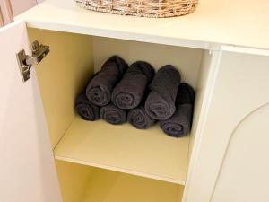 a pile of rolled towels in a cabinet at 스테이 느릿 in Seoul +68 photos
