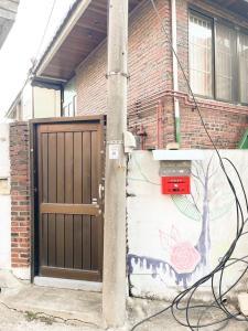 a house with a gate and a wall with a painting at 스테이 느릿 in Seoul