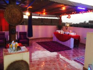 a room with a table with a red table cloth at Sphinx in Al Karnak