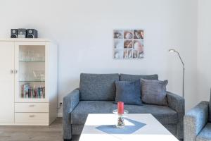 a living room with a couch and a table at Villa Marin, Wohnung 16 in Zinnowitz