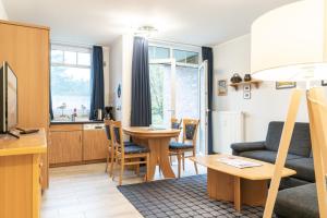 a living room with a couch and a table at Haus Roland, Wohnung 02 in Zinnowitz