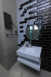 a bathroom with a white sink and a mirror at Matanak 2 in Munyonyo +22 photos