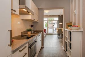 a kitchen with white cabinets and a counter top at Villa Marin, Wohnung 14 in Zinnowitz