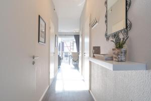 a hallway with a white counter and a mirror at Villa Marin, Wohnung 17 in Zinnowitz +21 photos