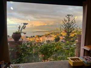 a view of a city from a window at La casa nell'aria Casa Scacciapensieri TAORMINA in Taormina