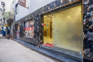a store front with a large window on a street at Hotel Ruhi Dx - Near New Delhi Railway Station & Connaught Place in New Delhi
