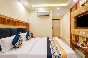 a bedroom with a large bed and a tv at Hotel Ruhi Dx - Near New Delhi Railway Station & Connaught Place in New Delhi