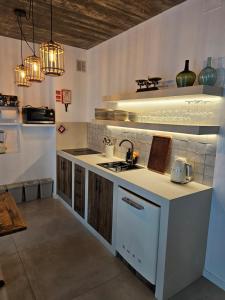 a kitchen with a sink and a counter top at Sunset Guesthouse - Costa Vicentina in Aljezur