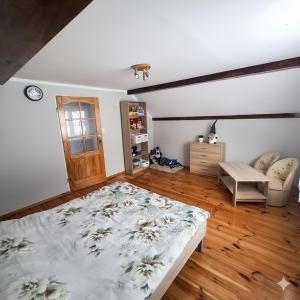 a bedroom with a large bed in a room at Agroturystyka u Janosika in Bozkow