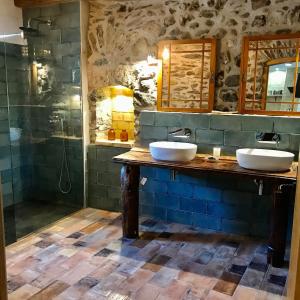 a bathroom with two sinks and a shower at Casa de piedra Siglo XVIII in Badaín