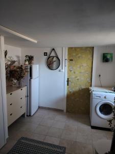 a kitchen with a washing machine and a washer at bords de loire in Saint-Sébastien-sur-Loire