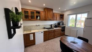 a kitchen with wooden cabinets and a wooden table at Mare è Muntagna in Mignataja