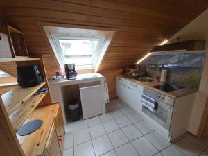 a small kitchen with a sink and a stove at Ferienwohnung Auf der Warthe in Florstadt +21 photos