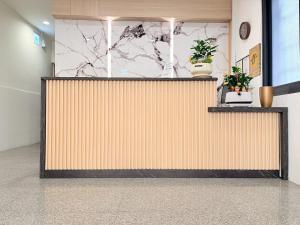 a reception desk in a lobby with plants at Jian Guo Hotel in Pingtung City