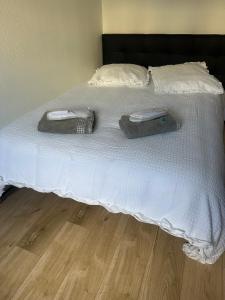 a bed with two towels on top of it at ici ville d'histoire in Nevers