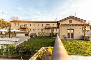 a large house with a yard in front of it at Vevi Villas in Vévi