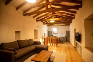 a living room with a couch and a table at Vevi Villas in Vévi
