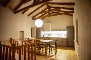a kitchen and dining room with a table and chairs at Vevi Villas in Vévi