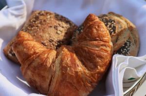 a plate of bread and croissants on a table at Forest Inn in Ugchelen +15 photos