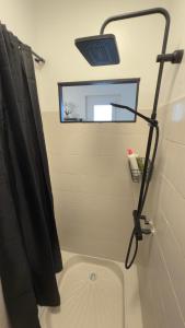 a bathroom with a black shower curtain and a mirror at Mare è Muntagna in Mignataja +40 photos