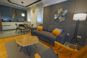 a living room with a couch and a table at Mia's Modern Mountain in Kolašin