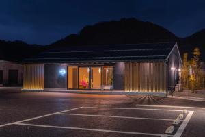 a building in a parking lot at night at 愛犬と泊まる丹後リゾート らぐら木津別邸 in Kyotango